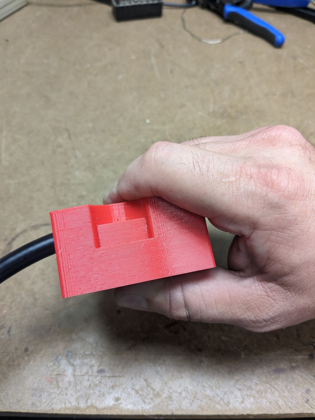 The RG-8 coax is inside of the stripper, The cutting blades are being pressed down into the coax.